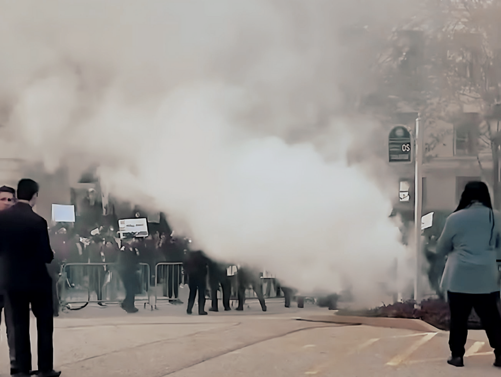 Protesters Set Off Smoke Bombs, Burn Effigy Of Conservative Speaker In Street